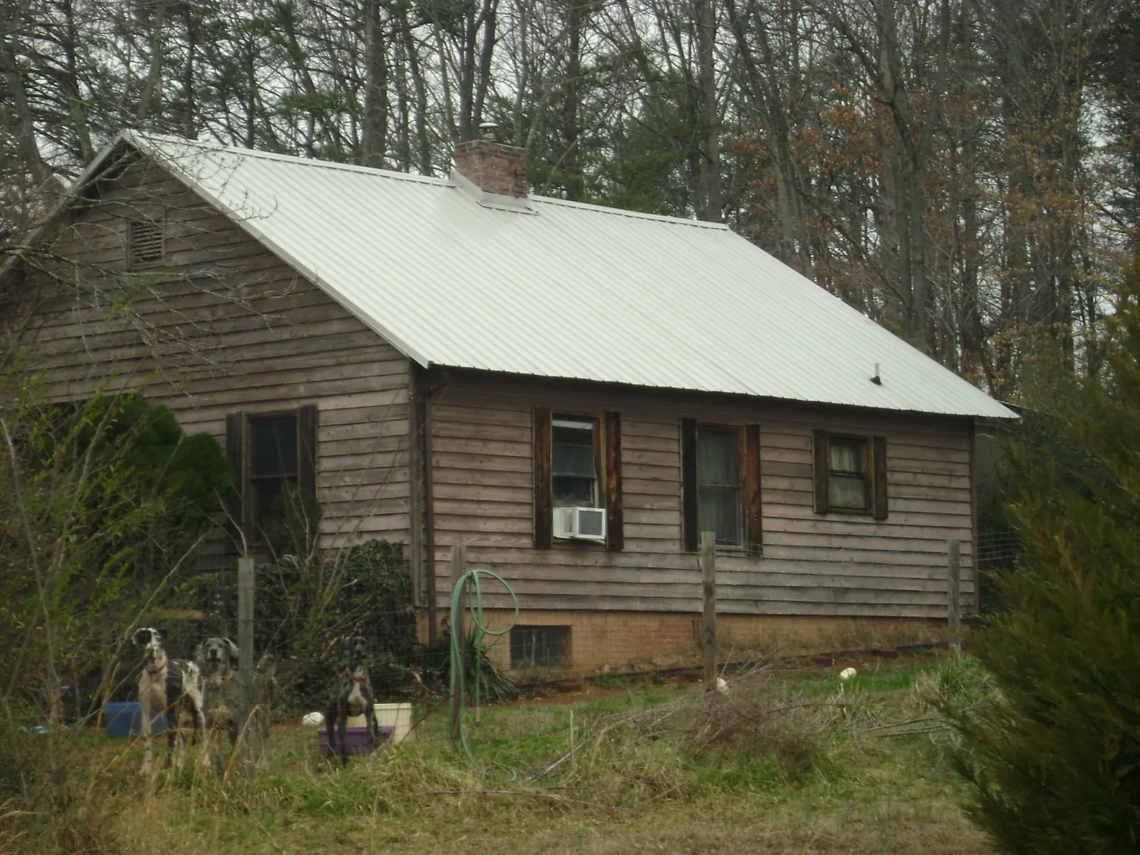 White metal roof on an old wood sided farmhouse, from a Metal Roof Installation job in Pocomoke City
